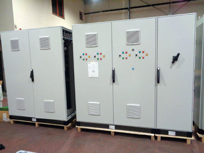 Electrical cabinet with control lights, rotary switches, measuring devices and fan grilles installed on the front panel, made using a CT2 punching machine and/or Grangier part cutters.
